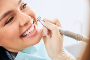 Cheerful female person demonstrating her smile while doing dental care interaction