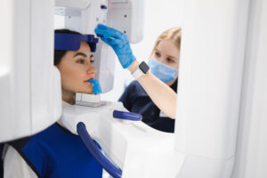 Woman makes a CT scan of the jaw. Dental assistant taking panoramic x-ray for female patient