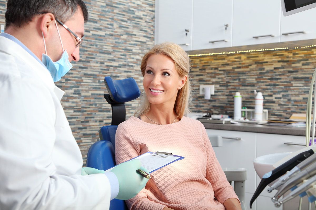 Dentist consulting with smiling patient