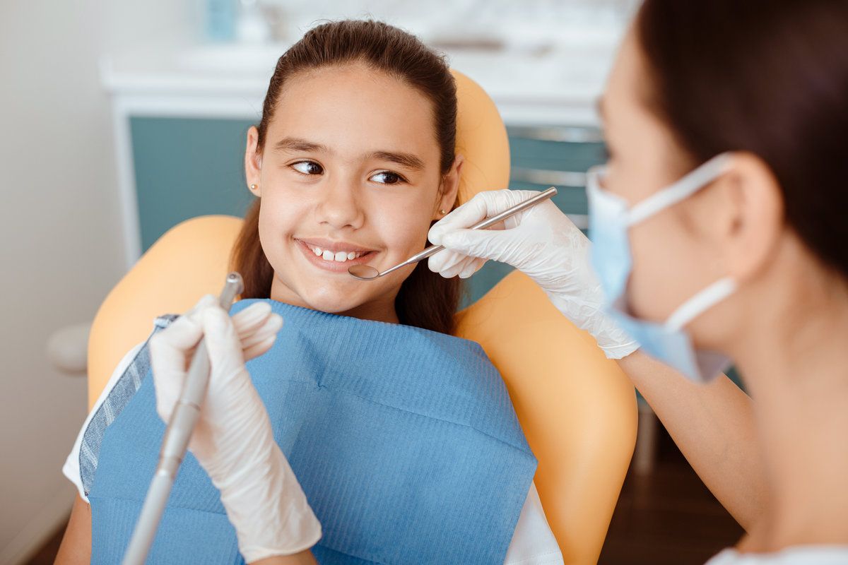 Girl at dentist smiling during checkup