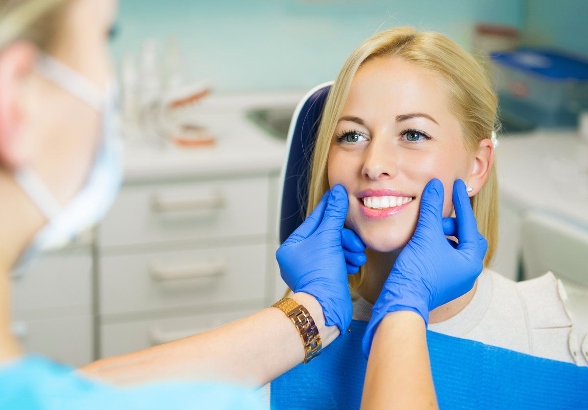 Dentist examining patient’s smile closely