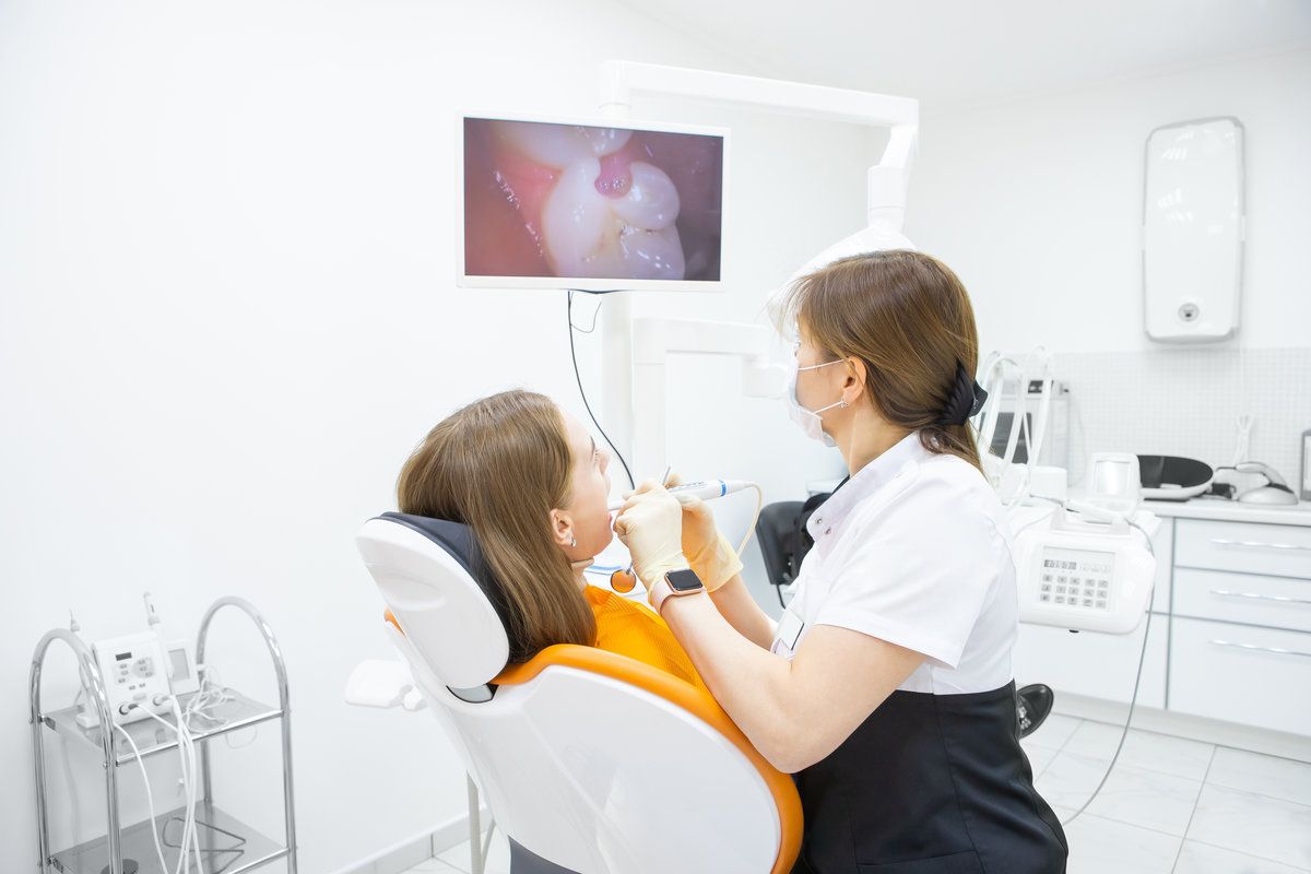 Dentist treating patient in clinic